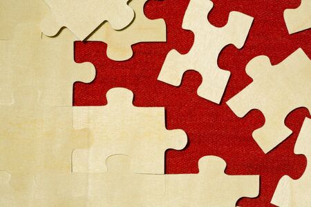 Pieces of jigsaw puzzle on red cloth