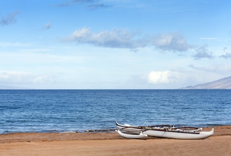 Outrigger canoe on sandy ocean beach, Maui, HIの写真素材