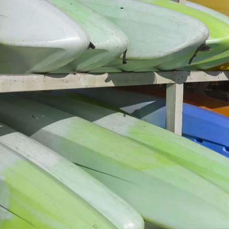 Stacking rack with colorful canoe boatsの写真素材