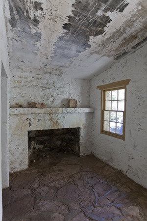 Room with a window and fireplace in stone and mortar historic Clevenger House, Thompson Arboretum State Park, Arizonaのeditorial素材