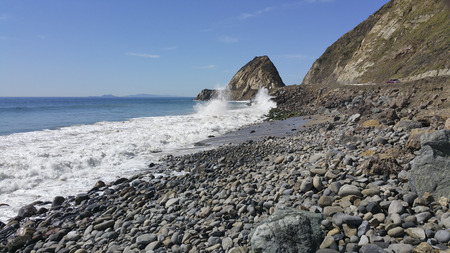 Breezy weather smashing waves at Point Mugu and distant Channel Islands as seen from Thornhill Broom Beach, La Jolla Canyon, Ventura county, CAの写真素材