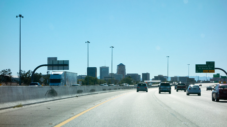 TUCSON, AZ â NOVEMBER 28, 2013, Interstate-10 running through downtown of a major Arizona city of Tucson full of high rise office buildings; back lit shot.のeditorial素材