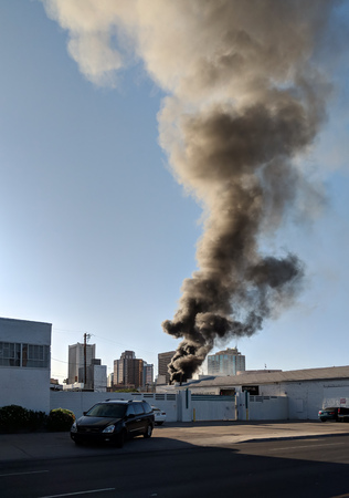 PHOENIX, AZ, USA - APRIL 19, 2018: Black smoke rising from a warehouse fire in city downtown,...
