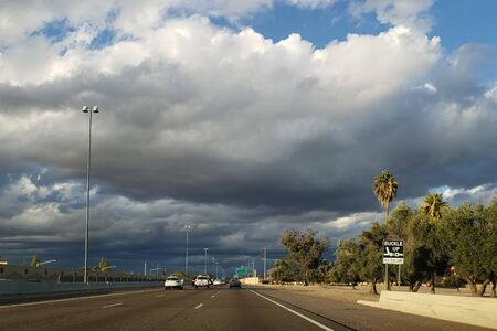 Dense storm clouds moving in North Phoenix metro area right above Interstate 17 highway