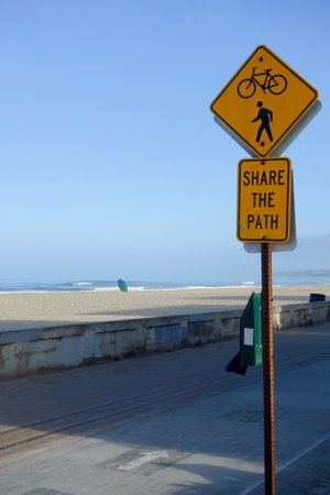 Beach side road sign about sharing path for bicyclist and pedestrians, ocean front walk at Mission beach in San Diego, Californiaの写真素材
