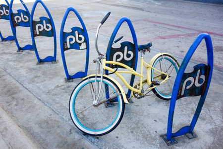 Lonely old bicycle securely locked to Pacific beach outdoor public bike parking rack, San Diego, Californiaの写真素材