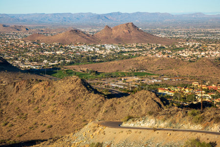 Backlit shot with star-shaped glare around sun of a paved service road that runs from the bottom to the top of North Mountain in  Phoenix, Arizonaの写真素材