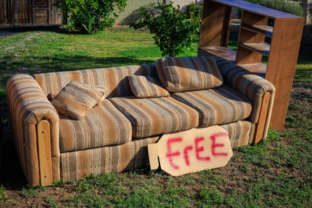 Free used furniture to go to other owners set outdoor on a green lawn during Spring cleaning in...