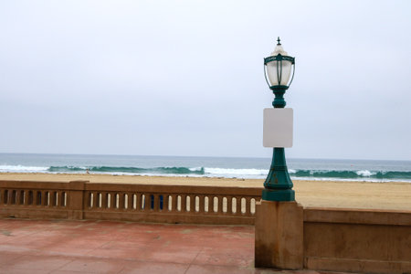 Classic street glass lamp on green metal post at Mission beach ocean front walk in the morning, San Diego, Southern Californiaの写真素材