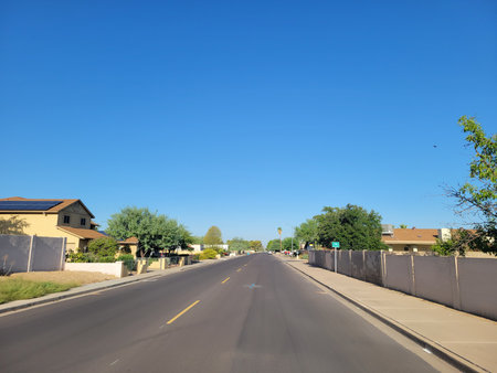 Arizona residential street with a designated Bike Route in the summer morning under clear blue skyの写真素材