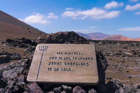 Information plate with the Achaja mountain name in Timanfaya National Park on Lanzarote, the Canary Islandsのeditorial素材