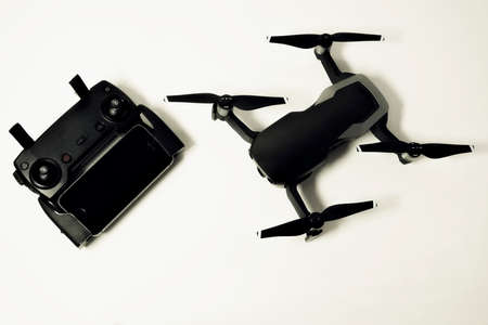 drone with controller and smartphone on white backgroundの写真素材