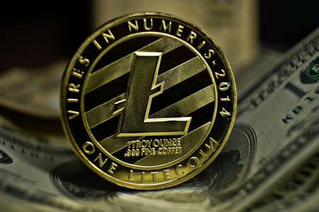 cryptocurrency, litetcoin coin laying on dollar banknoteの写真素材