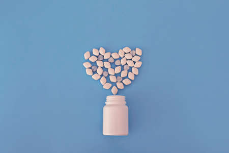 pharmaceutical medicine tablets and capsules. Heart shape and bottle of pills. Copy space for textの写真素材
