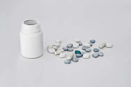 Medicines, supplements and drugs in a bottle on white backgroundの写真素材