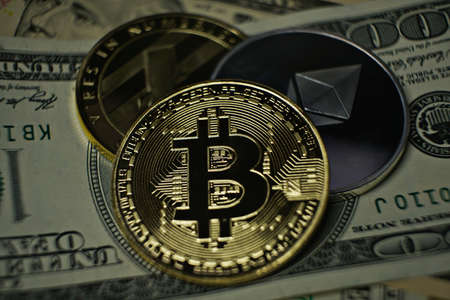 cryptocurrency, Bitcoin, litecoin, ethereum on dollar banknoteの写真素材