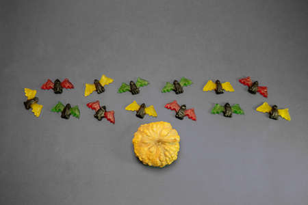 multicolored gummy jelly bat candies with pumpkin over dark backgroundの写真素材