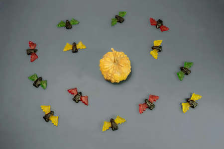 multicolored gummy jelly bat candies with pumpkin over dark backgroundの写真素材