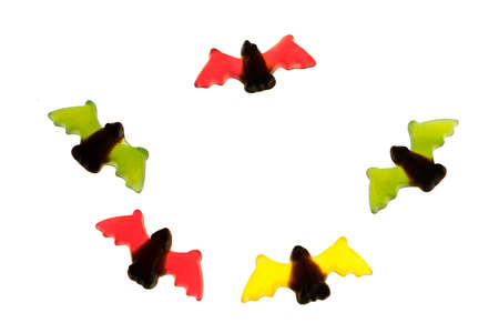 multicolored gummy jelly bat candies over white backgroundの写真素材