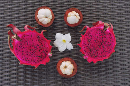 Dragon fruit and mangosteen on woodの写真素材
