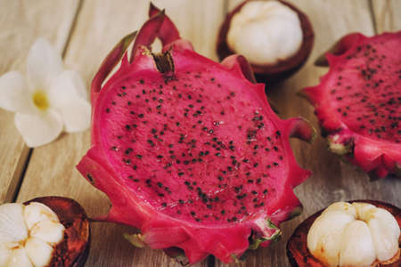 Dragon fruit and mangosteen on woodの写真素材