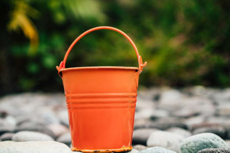 Coral watering buckets for plants in gardenの写真素材