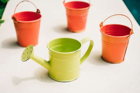 Colorful watering buckets for plants at flowerの写真素材