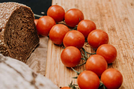 Fresh bread on paper on wooden backgroundの写真素材