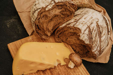 Fresh bread, champingnon mushrooms, cheese on wooden backgroundの写真素材