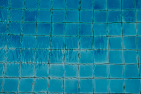Pure blue water the pool. Water caustic backgroundの写真素材