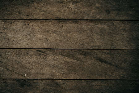 Old dark brown wooden background with vignetteの写真素材