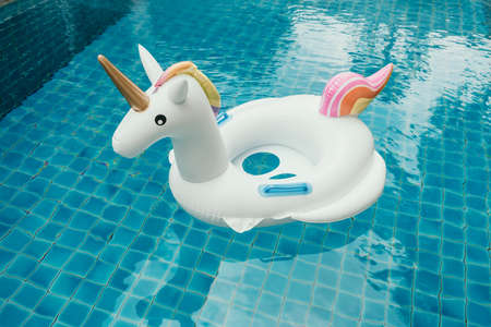 Unicorn pool float in blue water in poolの写真素材