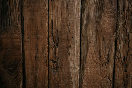 Old dark brown wooden background with vignetteの写真素材