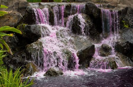 Waterfall with pink waterの写真素材