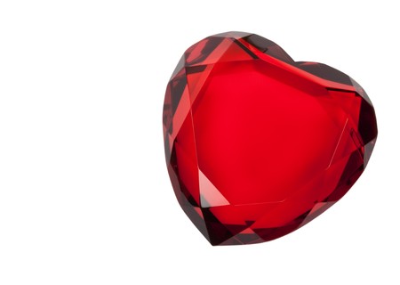 Red cut glass heart paperweight isolated on whiteの写真素材