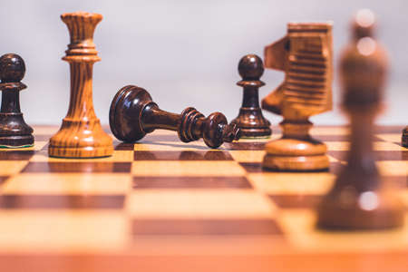 Chess board with the chips and the king lying in checkmateの写真素材