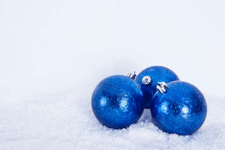 Christmas greeting background, blue balls on white snow background. . High quality photoの写真素材