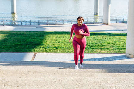 Young black woman exercising, running up steps. High quality photoの写真素材