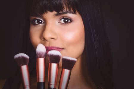 Portrait of a professional make-up artist with brushes. High quality photoの写真素材