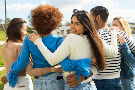 Friends hugging each other having a good time in the park, friendship concept. High quality photoの写真素材