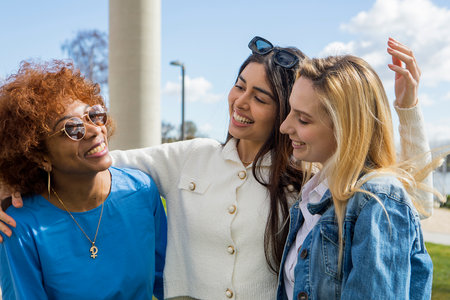 three girlfriends having fun in the park, friendship concept, laughter. High quality photosの写真素材