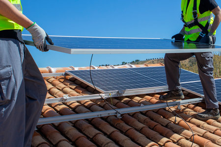 workers installing solar panels on the roof. High quality photos