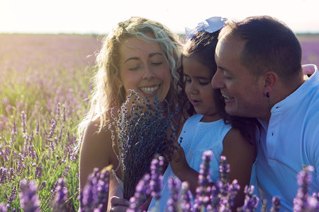 Beautiful young family on purple flower lavender field. Family vacation. High quality photosの写真素材
