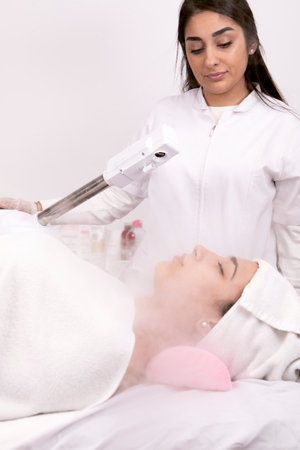 Beauty treatment of face with ozone facial steamer in beauty center. . High quality photoの写真素材