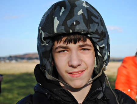 A young man in a military helmet is against aircraftの写真素材