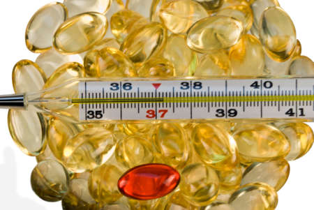 Yellow, one red pill and thermometer shows 37 2の写真素材
