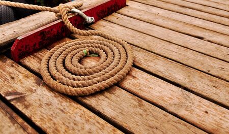 Marine rope spiral on wooden deck 