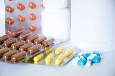 Assorted pharmaceutical medicine pills, tablets and capsules with white background.の写真素材