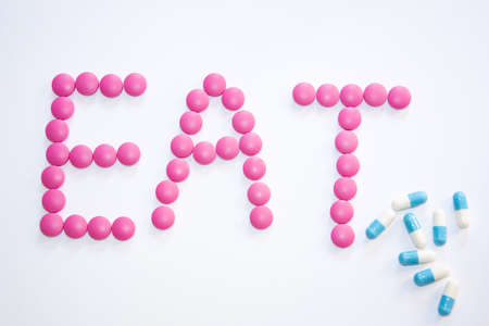 Assorted pharmaceutical medicine pills, tablets and capsules with white background.の写真素材