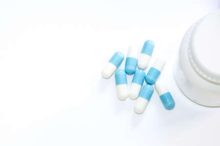 Assorted pharmaceutical medicine pills, tablets and capsules with white background.の写真素材
